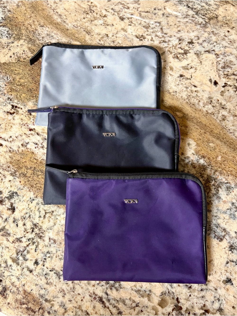 Set of Three TUMI Travel Pouches in Purple, Black & Gray